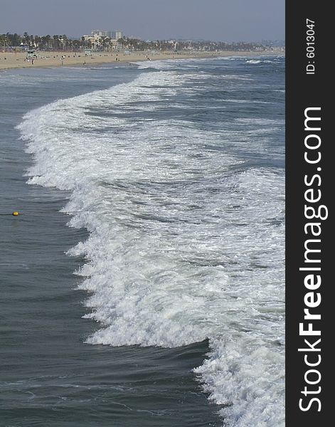 Waves coming ashore on sunny afternoon at Santa Monica Beach in California. Waves coming ashore on sunny afternoon at Santa Monica Beach in California.