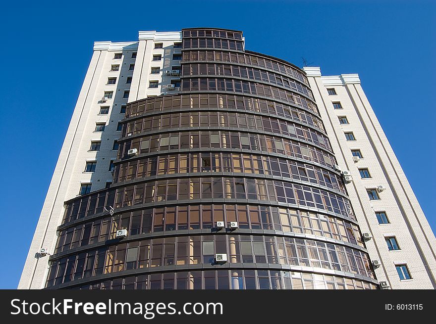 High modern office building with blue sky background