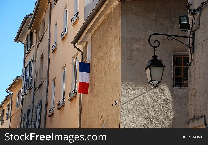 Flag hanging off old city building, Aix en Provence, France. Flag hanging off old city building, Aix en Provence, France.