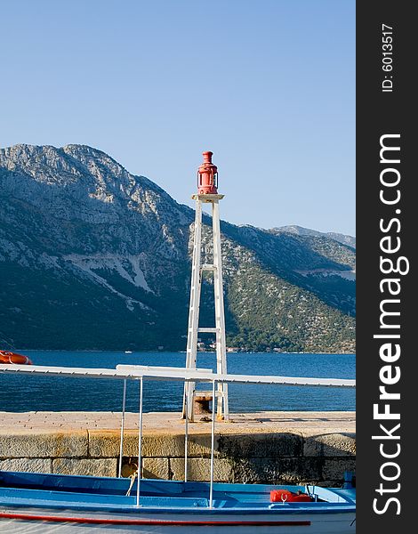 Small lighthouse and boat at dock