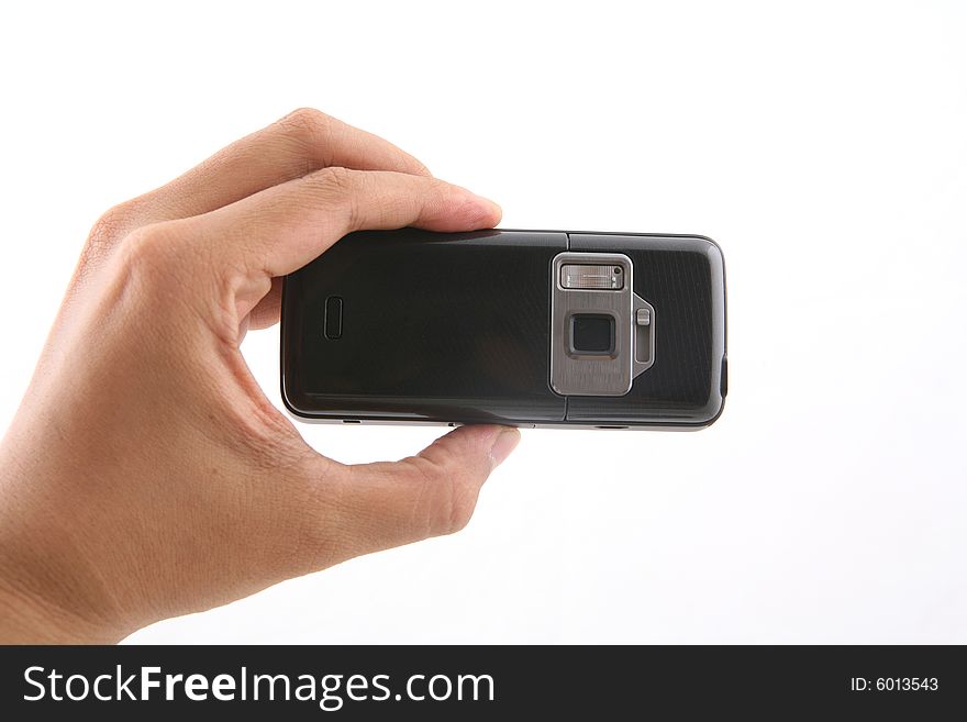 A man is holding a black cameraphone shot over white background. A man is holding a black cameraphone shot over white background