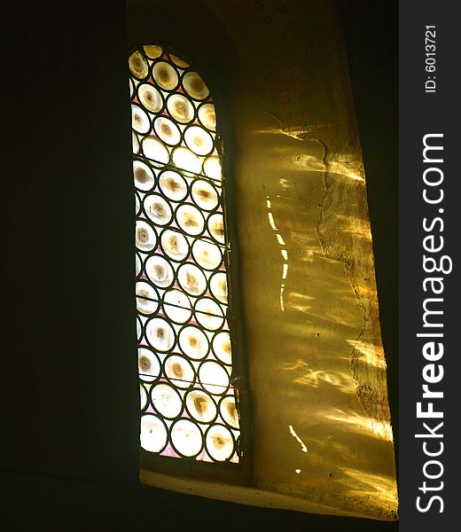 A suggestive shot of a stained-glass window in the Montesiepi hermitage in Tuscany