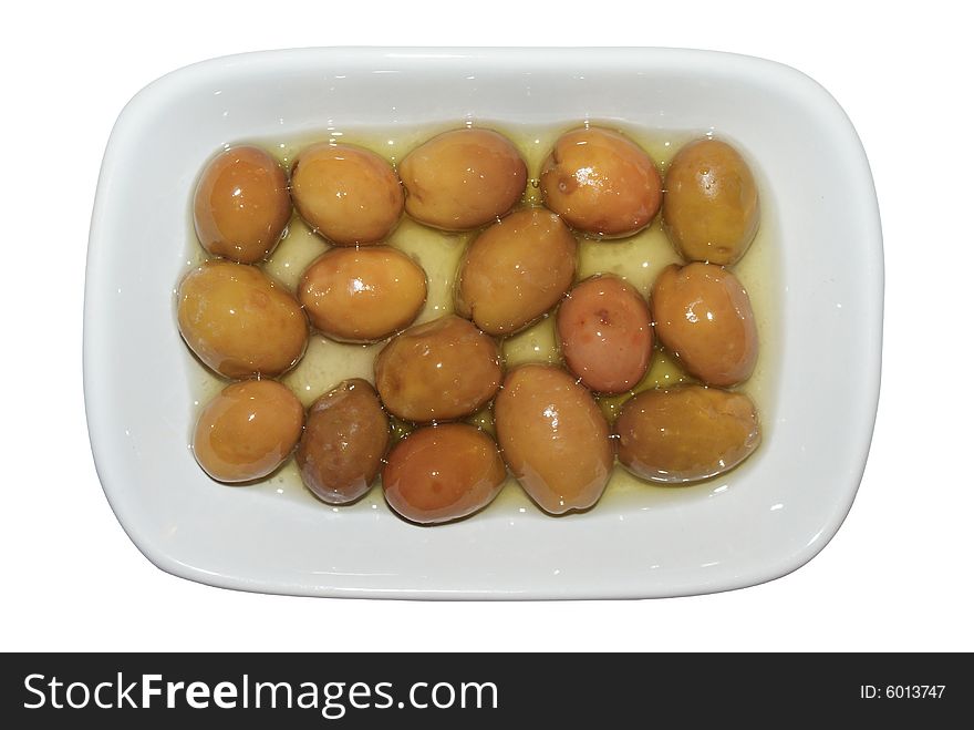 Green olives in a cup with olive oil