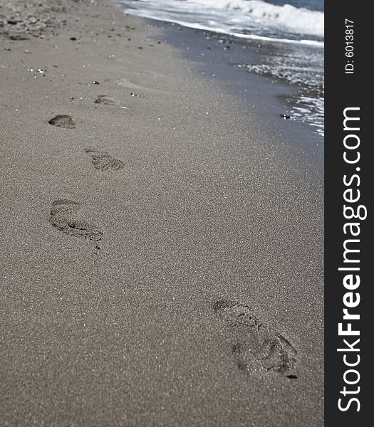 Footsteps on the beach in a Greece