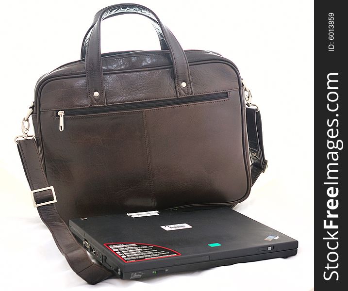 Notebook computer with leather by black bag for carrying purposes