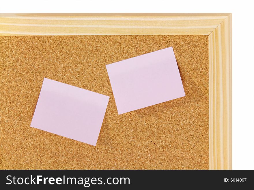 Pink sticky notes on brown corkboard with wooden frame