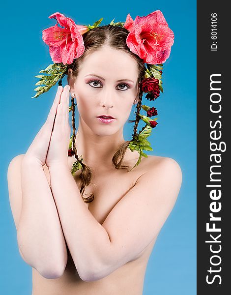 Young woman with big flowers in her hair. Young woman with big flowers in her hair