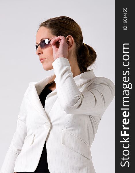 Young sturdy woman with sunglasses on a white background. Young sturdy woman with sunglasses on a white background