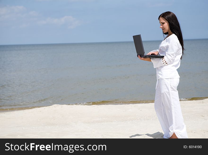 Attractive brunette woman relaxing on the beach. Attractive brunette woman relaxing on the beach