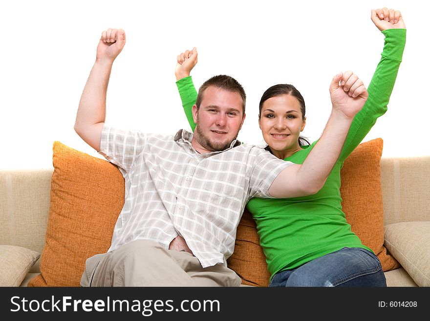 Happy couple sitting together on sofa. Happy couple sitting together on sofa