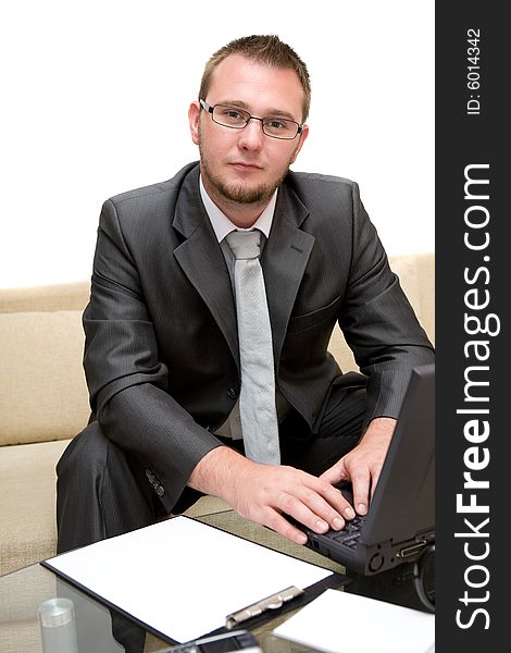 Happy man sitting on sofa with laptop. Happy man sitting on sofa with laptop