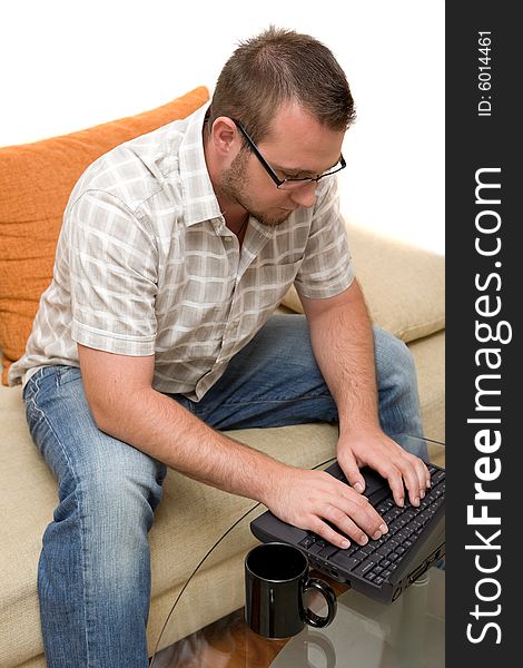 Happy man sitting on sofa with laptop. Happy man sitting on sofa with laptop