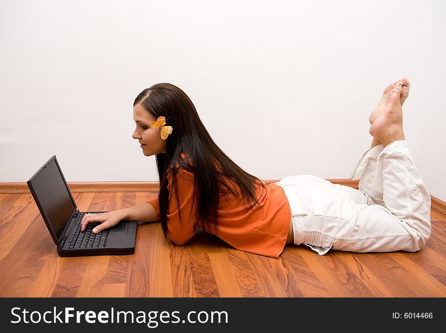 Casual woman lying on flor with laptop. Casual woman lying on flor with laptop