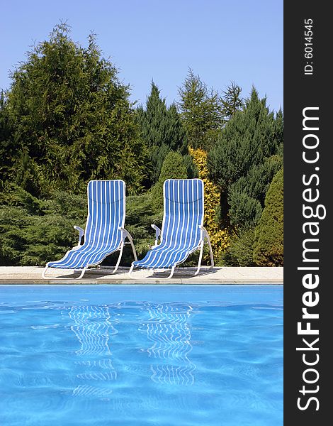 Two deckchairs at the pool. Two deckchairs at the pool