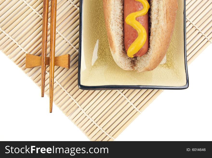 East Meets West - Hot Dog and Chopsticks Isolated on a White Background