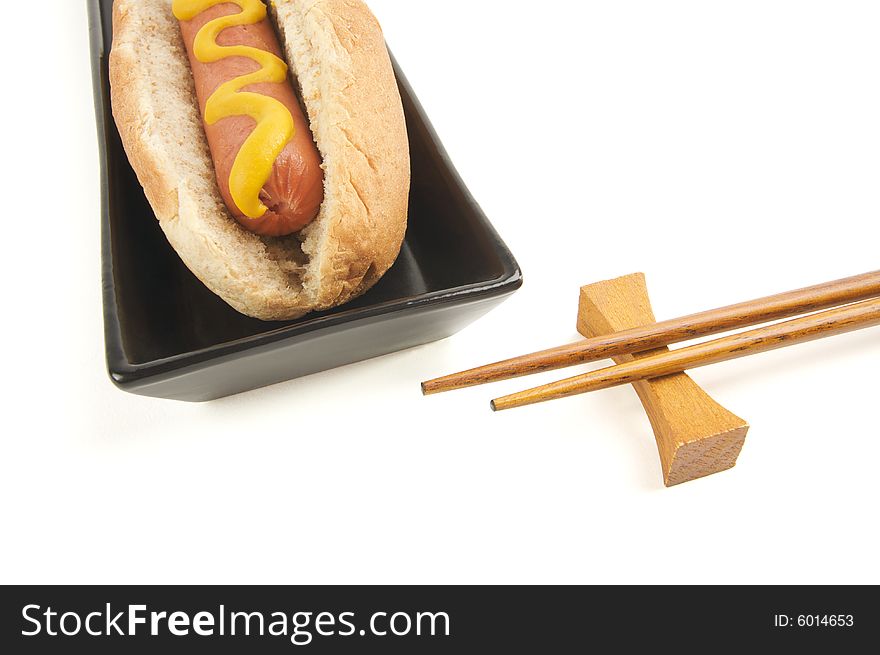 East Meets West - Hot Dog and Chopsticks Isolated on a White Background