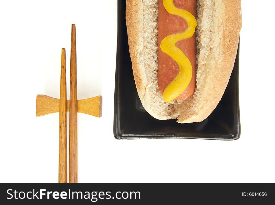 East Meets West - Hot Dog and Chopsticks Isolated on a White Background