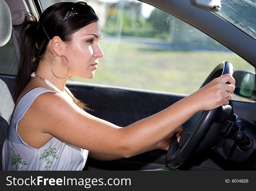 Attractive brunette woman traveling by car. Attractive brunette woman traveling by car