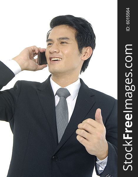 Man in suit on cell phone looking happy and laughing. Man in suit on cell phone looking happy and laughing
