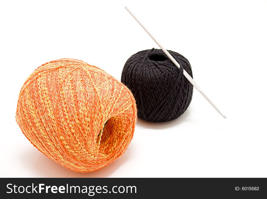 Two balls with crochet hook. Two balls with crochet hook