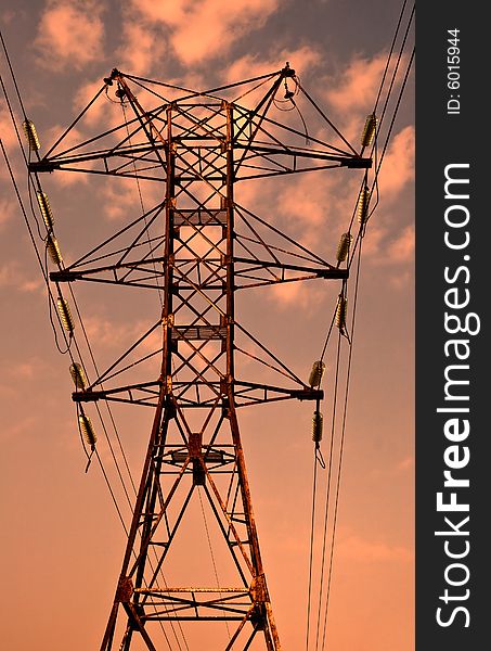 Power transmission pole against sunset skies. Power transmission pole against sunset skies