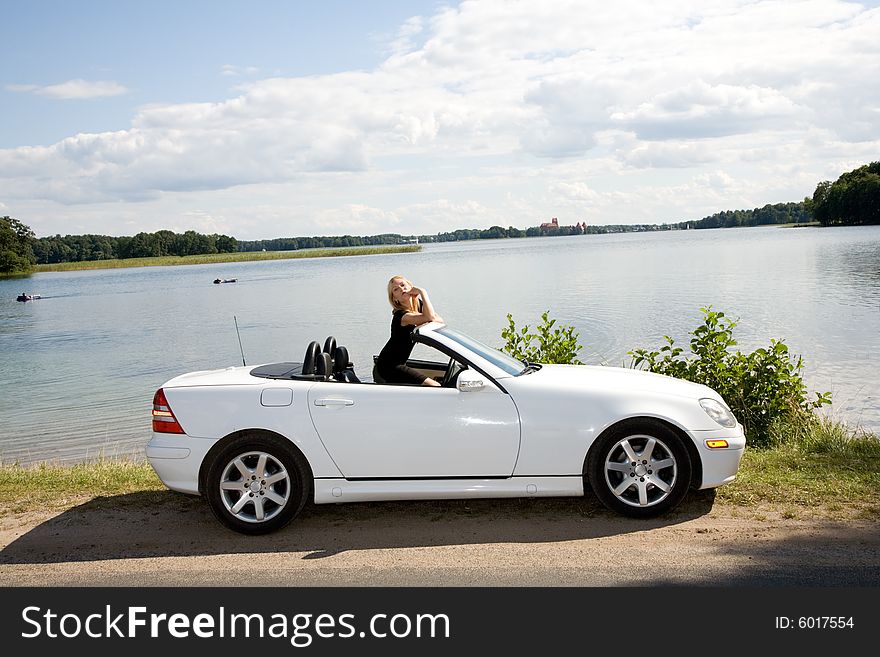 Portrait of the beautiful young girl with cabriolet