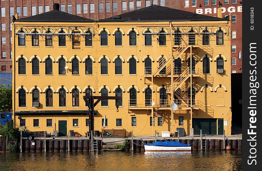 Bright yellow building or condo on the waterfront. Bright yellow building or condo on the waterfront