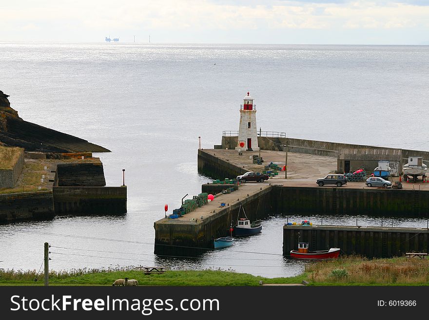 A small harbour is a safe place to be when the sea is not as calm. Lybster, northern Scotland. A small harbour is a safe place to be when the sea is not as calm. Lybster, northern Scotland