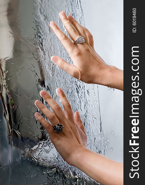 Hand with rings on water background