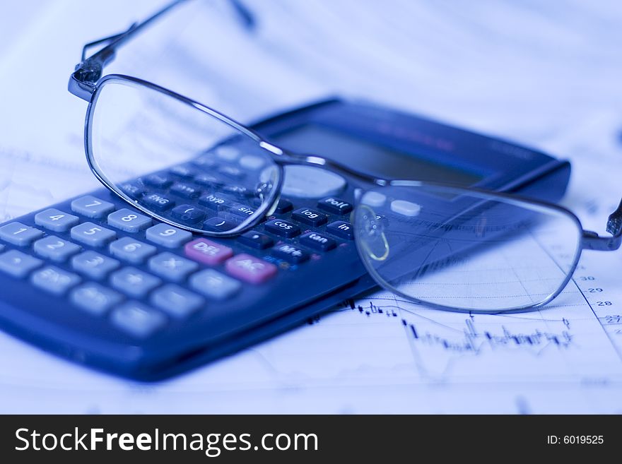 Financial chart with glasses and calculator. Financial chart with glasses and calculator