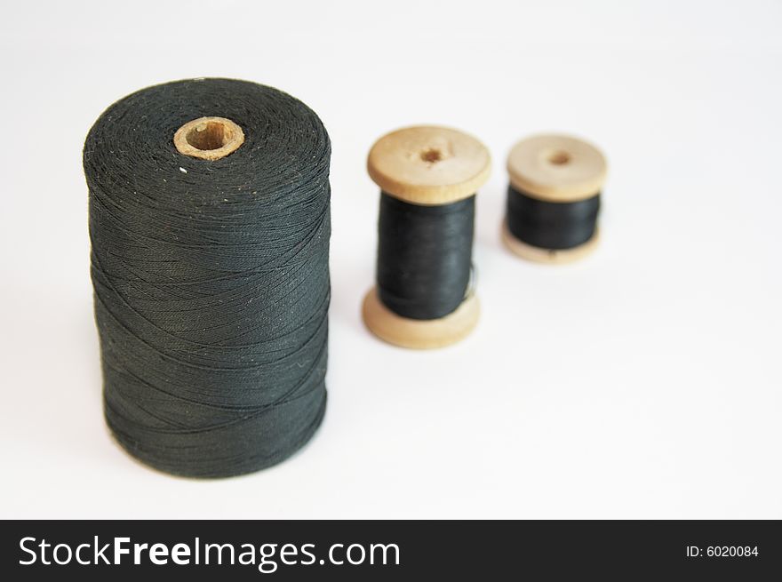 Three coils with black threads. Three coils with black threads