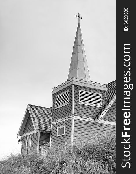 Black and white photo of an old rustic country church sitting on a hilltop. Black and white photo of an old rustic country church sitting on a hilltop