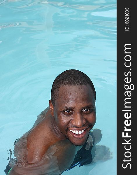 Man smiling while in a swimming pool. Man smiling while in a swimming pool