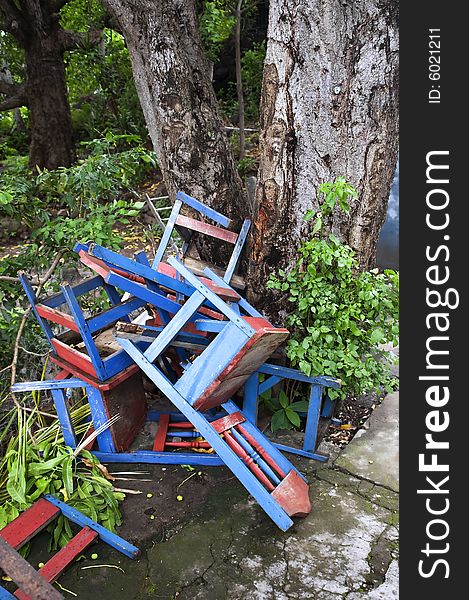 Colorful discarded chairs near a tree in Nicaragua. Colorful discarded chairs near a tree in Nicaragua