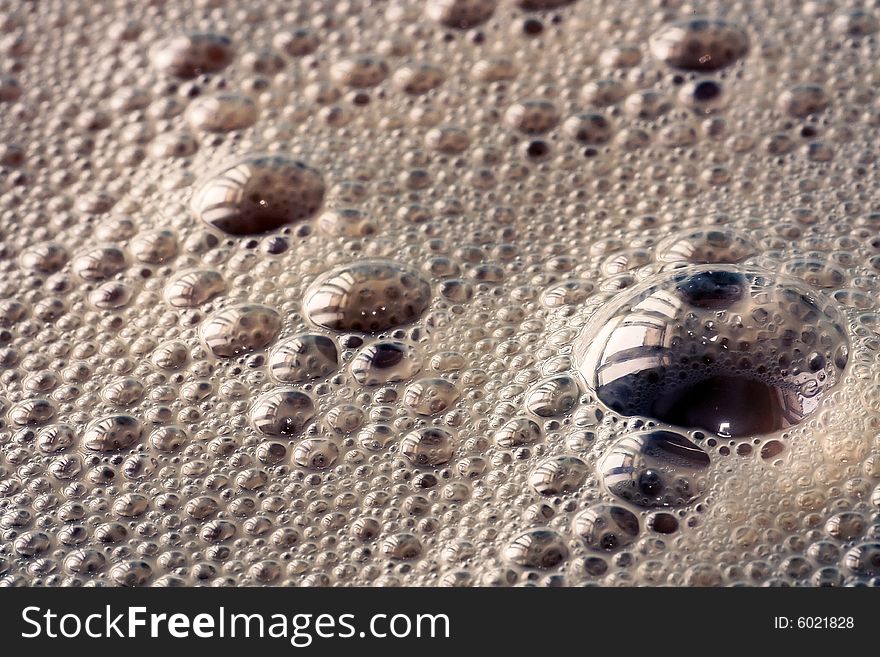 Closeup on some big and small foam bubbles,