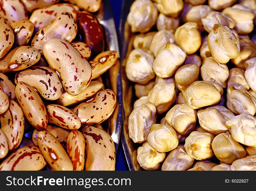 Bunch of pinto beans and chickpeas, piled on each of it's plate. Bunch of pinto beans and chickpeas, piled on each of it's plate.