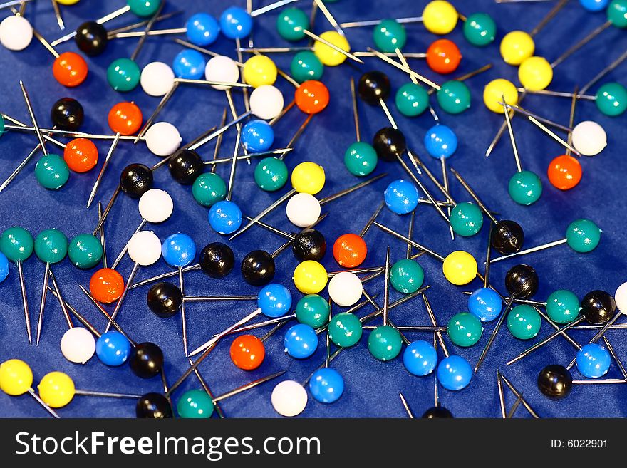 Bunch of colorful board pins spreaded over the table.