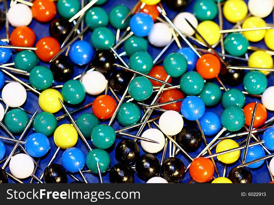 Bunch of colorful board pins spreaded over the table.