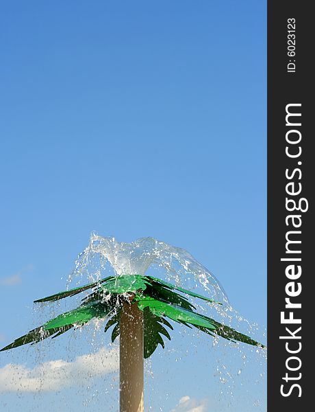 Water shooting fro the top of a man made steel palm tree at a Spray park. Water shooting fro the top of a man made steel palm tree at a Spray park