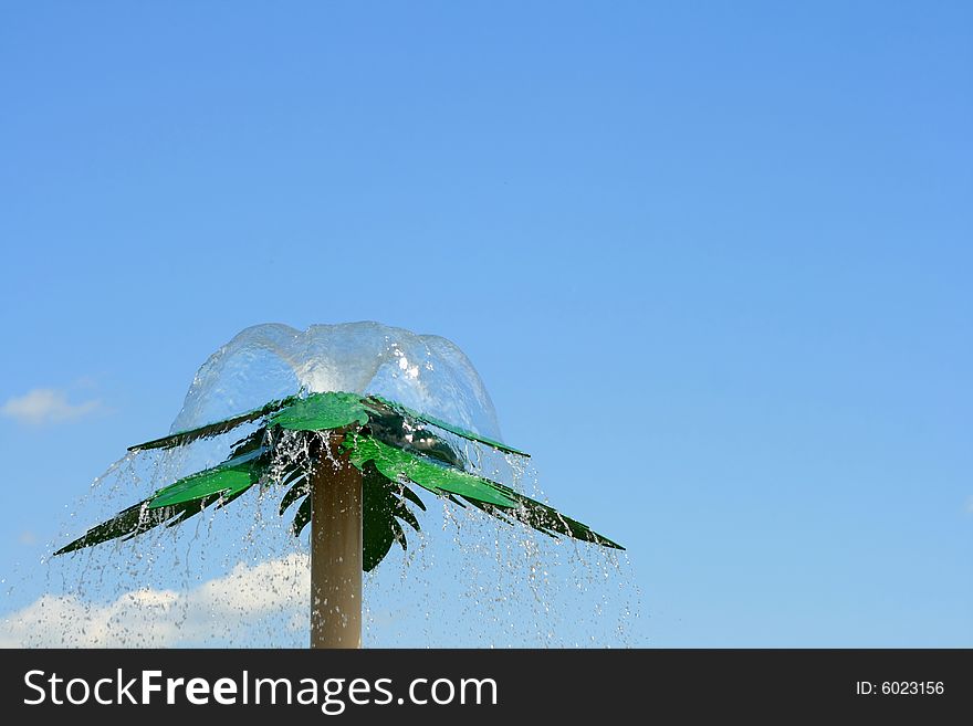 Water shooting fro the top of a man made steel palm tree at a Spray park. Water shooting fro the top of a man made steel palm tree at a Spray park