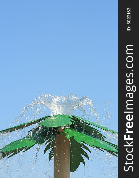 Water shooting fro the top of a man made steel palm tree at a Spray park. Water shooting fro the top of a man made steel palm tree at a Spray park