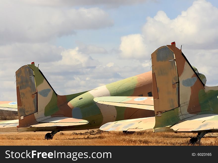 Detail of the tail sections on two old camoflaged aircraft. Detail of the tail sections on two old camoflaged aircraft