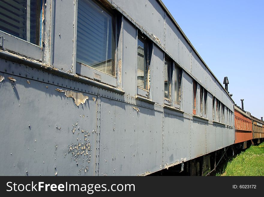 Detail of a partially restored vintage train stretching off into the distance. Detail of a partially restored vintage train stretching off into the distance