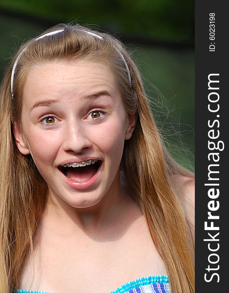 Teenager with headband and braces with surprised expression. Teenager with headband and braces with surprised expression.