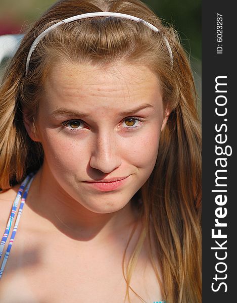 Teenager with headband and doubtful expression. Teenager with headband and doubtful expression.