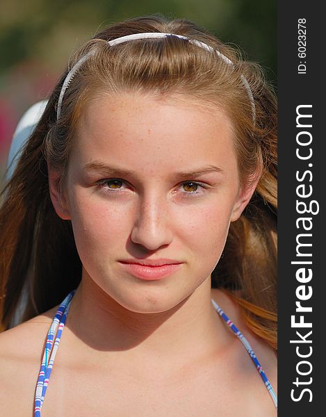 Teenager with headband and bathing suit before afternoon swim.