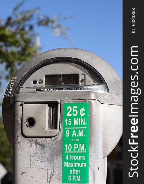 Parking meter on a blue sky.