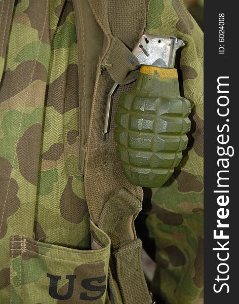 A soldier carrying a grenade. A soldier carrying a grenade