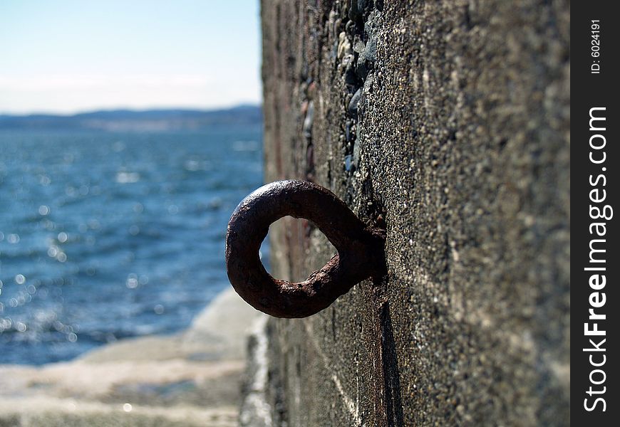 A hook on the side of a cement wall. A hook on the side of a cement wall.