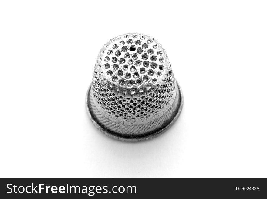 Old thimble on white background